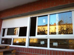 Colocación de ventanas correderas en aluminio blanco con cristal laminado de seguridad antirotura en escuela de Montornès del Vallès.